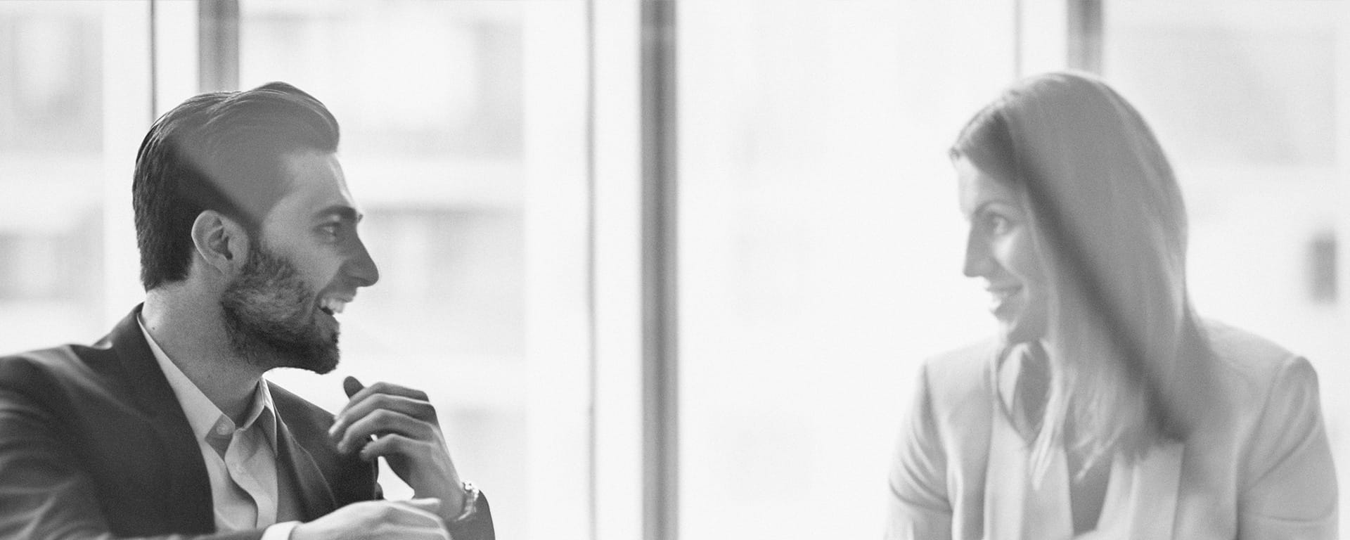 Man and woman talking in front of a window