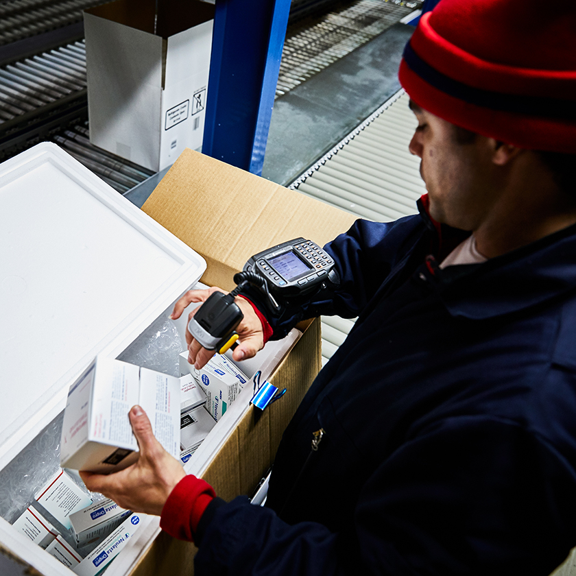 Warehouse worker scanning items to place into a cooler