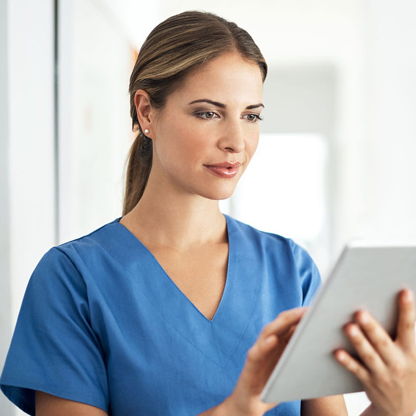 Female medical professional looking at a tablet